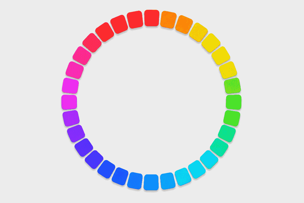 Un anneau de nombreuses petites pastilles de couleur disposées en cercle, passant en douceur par le rouge, l'orange, le jaune, le vert, le cyan, le bleu, le violet et le magenta pour revenir au rouge